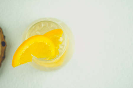 A glass of water with ice cubes and slices of fresh orange. Summer drinkの写真素材