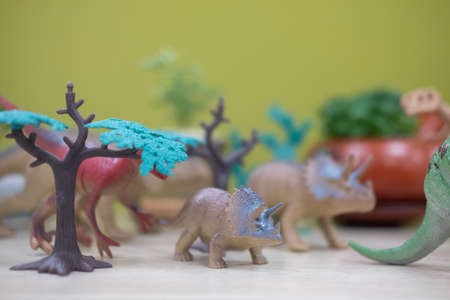 Selective focus of a crowd gathered of toy plastic dinosaursの写真素材