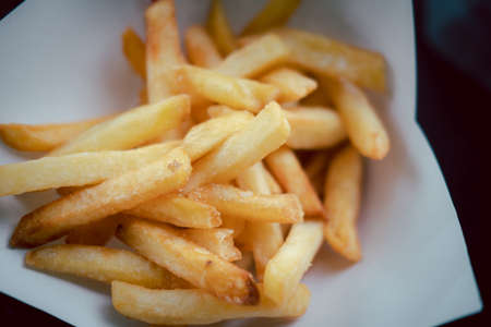 Full of fresh french fries on paper bowl. Selective focus