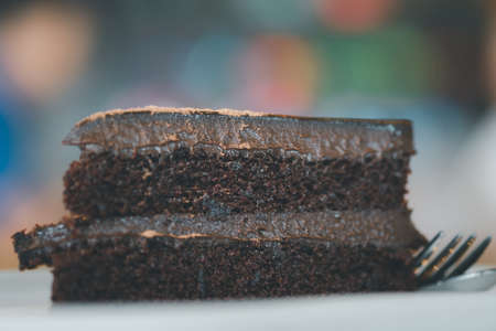 Chocolate fudge cake sliced in cafe. Selective focus