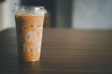 Samut Prakan, Thailand - October 25, 2020 : Iced Mocha coffee take away at Inthanin coffee shop. Inthanin is beverage shop in Bangchak oil station. A beverage container that can be decomposed naturallのeditorial素材
