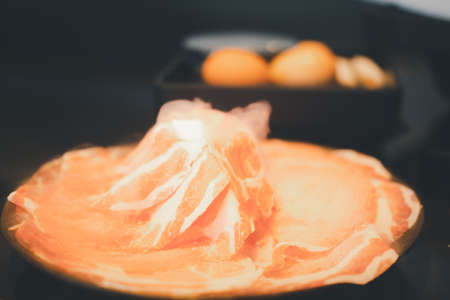 Close up Premium sliced Kurobuta pork with high-marbled texture served for Sukiyaki and Shabu.