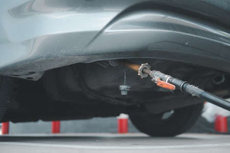 Car at gas station being filled with fuel, fill up of liquefied petroleum gas, LPG. Close upの写真素材