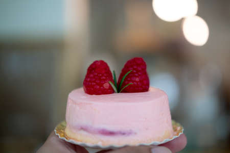 Cream rose mousse dessert on top with raspberry. Selective focusの写真素材