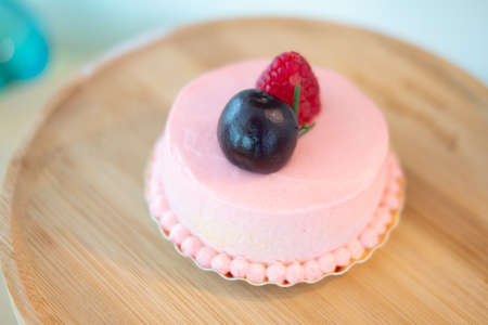 Cream rose mousse dessert on top with raspberry. Selective focusの写真素材