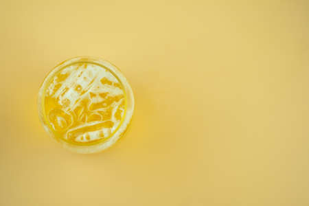 A glass of beer on yellow background. Top viewの写真素材