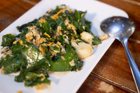 Stir-fried Malindjo leaves with egg. This menu is favorite in the south of Thailand