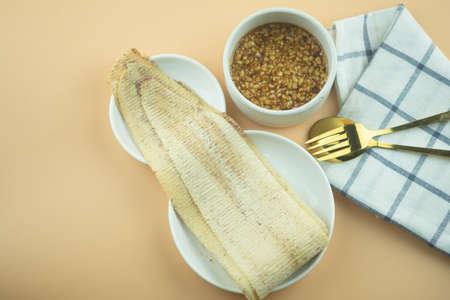 Dried cuttlefish that from grind from the grinder served with with spicy and sweet peanut sauce. This is one of the interesting Thai street food menusの写真素材