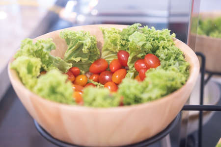 Vegetables salad bar buffet in hotel restaurant. Fresh vegetables in wood bowlの写真素材