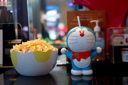 Bangkok, Thailand - November 21, 2020 : Cute toy of Doraemon set of bucket popcorn and soft drink to promote the movie : Nobita's New Dinosaur from Advertising Major Cineplex Group Plc.のeditorial素材