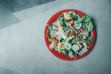 Spicy pork salad with mixed vegetable on red plate. Thai style homemade foodの写真素材