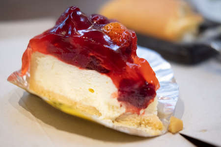Bite cheesecake with fresh berries and sweet strawberry sauce. Close upの写真素材