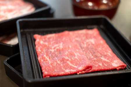 Premium grade of fresh raw thin sliced beef for Shabu Shabu or Yakinikuの写真素材
