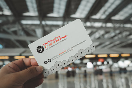 Bangkok, Thailand - December 9, 2020 : Close Up of man holding boarding pass of AirAsia flight at Suvarnabhumi airportのeditorial素材