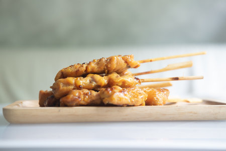 Sticks of grilled skewered turmeric chicken one of the famous street food in Thailand