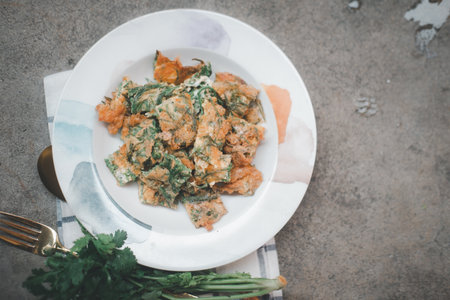 Fried acacia pennata omelet or cha-om egg. Thai food