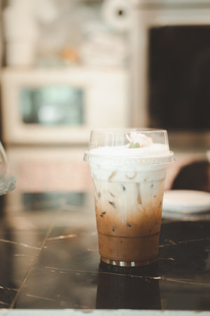 Iced coffee or mocha with fresh milk mixing in take away cupの写真素材