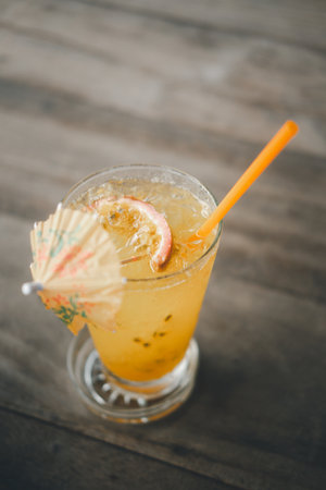 Passion fruit juice in glass on wood table