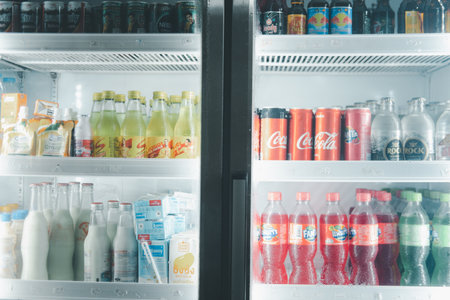 Samut Prakan, Thailand - December 13, 2020 : A variety brands of beverages, sparking water, fruits juice, milk and energy drink are placed on display in the refrigerator Thai grocery store.のeditorial素材