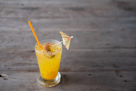 Passion fruit juice on wood table at cafeの写真素材