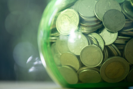Money coins Thai baht in a green round glass jar. Close upの写真素材