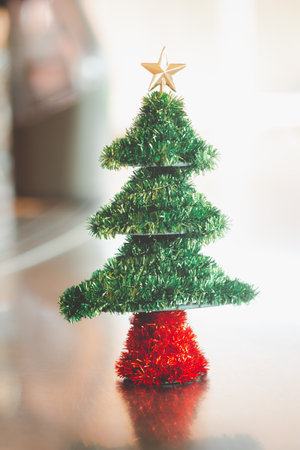Small green Christmas tree decorated in homeの写真素材