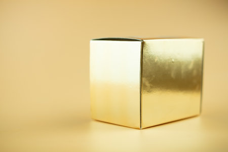 Gold package box on yellow background