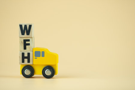 Wooden block word of WFH on toy pickup truck. Concept of work from home during the Coronavirus crisisの写真素材