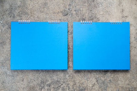 Blue blank paper desk spiral calendar on cement backgroundの写真素材