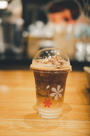 Bangkok, Thailand - January 5, 2021 : Iced Mocha coffee in take away glass on table at Inthanin coffee shopsのeditorial素材
