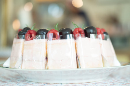 Cake cream rose decoration with fresh raspberries and fresh berries. Selective focus