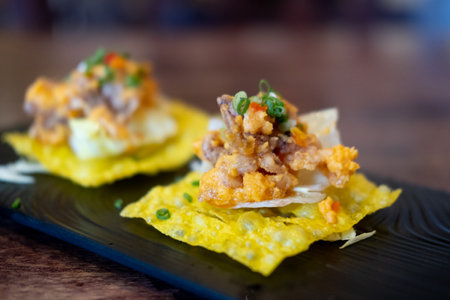 Fried squid and salted egg served on fried dumplings. Selective focusの写真素材