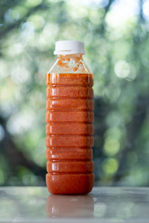 Suki sauce with white sesame for health good sodium in plastic bottle on blur nature backgroundの写真素材