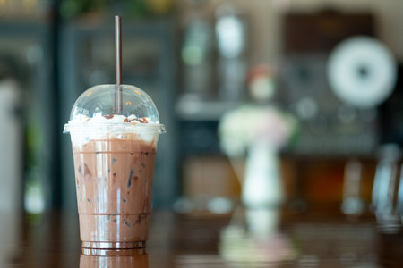 Close up of a glass of Iced Cocoa cool drink served on table with blur backgroundの写真素材
