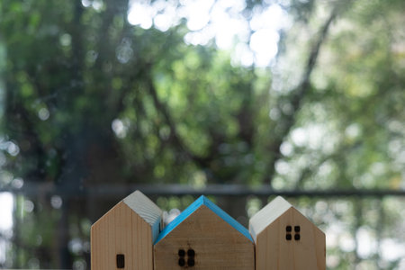 Row of wooden miniature home with beautiful nature background. Concept of buying a house, real estate market or mortgage loan.の写真素材