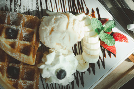 Fresh waffles with ice cream served with banana and strawberry. Food and dessert conceptの写真素材