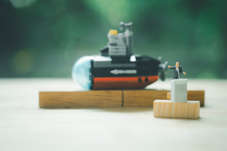 Miniature people of a politician stand on podium during a public speaking of submarine. Concept of policyの写真素材