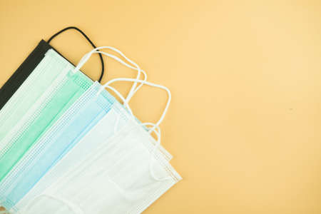 Disposable surgical mask. Three-layer medical mask protects from bacteria, viruses and dust, reduces the risk of infection. Airborne disease protection concept.の写真素材