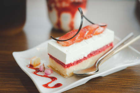 Fresh strawberry cheesecake on rectangle white plate