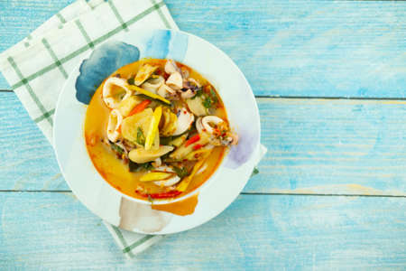 Hot chili tom yum with squid, red peppers, lime juice, galangal, fish sauce, lemongrass. Traditional...