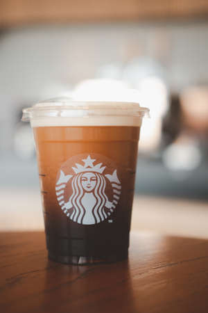 Bangkok, Thailand - January 19, 2021 : Starbucks Nitro Cold Brew Coffee in the Starbucks take away plastic cup. Starbucks is the world's largest coffee house with over 20,000 stores in 61 countries.のeditorial素材