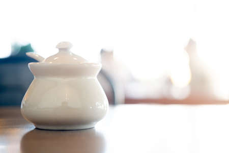 Small ceramic bowl with lid for put Thai flavoring such as fish sauce chili, sugar, fish sauce, chili or groundnut on wood tableの写真素材