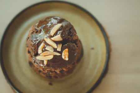 Close up of delicious chocolate scone with nut on wood table