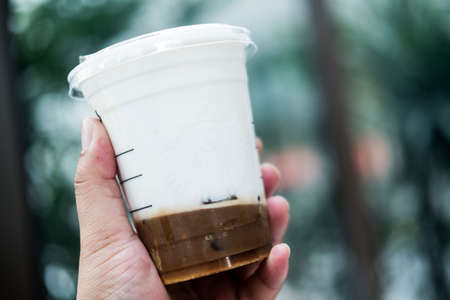 Bangkok, Thailand - February 28, 2021: Starbucks iced Salted Caramel Cloud Macchiato. Espresso shot poured through soft milk foam. Add the sweetness of the salted caramel syrup and caramel sauce on the milk froth.のeditorial素材