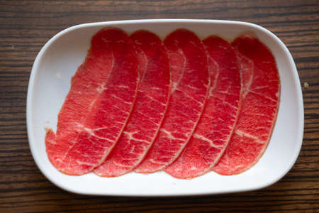 Thin sliced raw beef to prepare for Shabu Shabuの写真素材