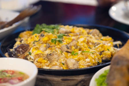 Oyster omelette served in hot pan, Thai style mussel omelette. Selective focusの写真素材