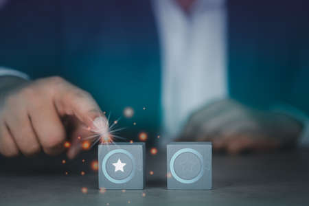 Customer choose star shape icon on wood cube it mean the best excellent services. Concept of rating customer experience. Best excellent services rating for satisfaction presentの写真素材