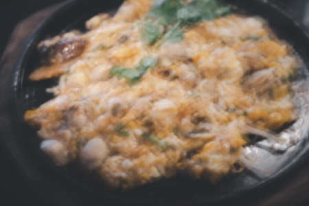 Blur background of oyster omelette in hot pan. Background foodの写真素材