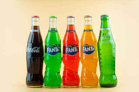 Samut Prakan, Thailand - March 20, 2021 : Popular soft drink in glass bottle volume 375 ML. such as Coca-Cola, Fanta of three flavour and Sprite on a orange backgroundのeditorial素材