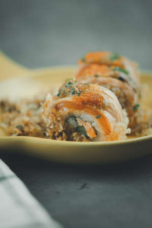 Smoked salmon rolls served on a yellow plate. Selective focusの写真素材